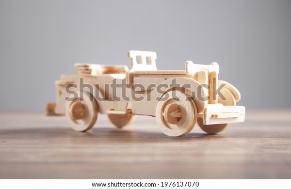 Old wooden retro toy\
car on the table.