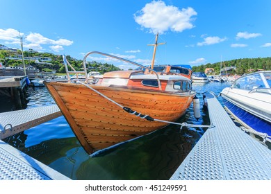 Old Wooden Row Boat In Harbor At Norway