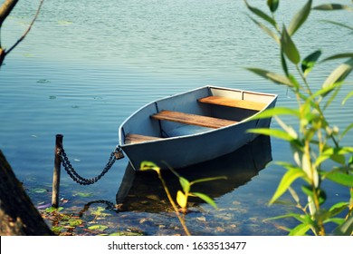 Old Wooden Row Boat On The Water