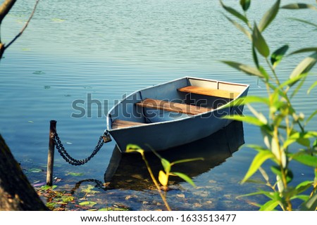 Old wooden row boat on the water