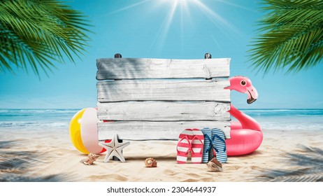 Old wooden sign and colorful beach accessories on the sand, tropical ocean in the background, summer vacations concept - Powered by Shutterstock