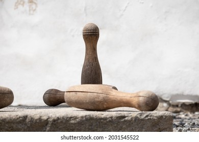 Old wooden skittles with wall on background