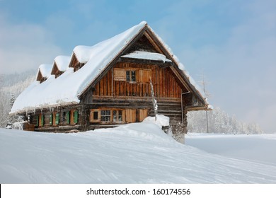 Old, Wooden, Snowy Ski Lodge In The Alps