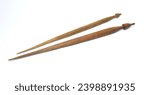 Old wooden spindles for spinning wool on white background