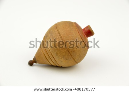 Old wooden spinning top on a white background