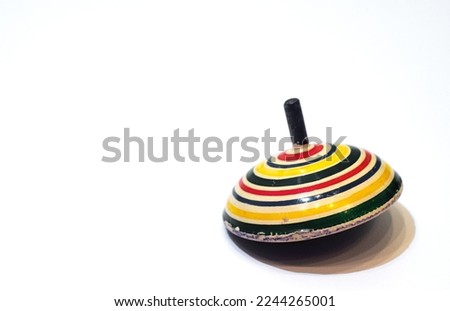 An old wooden spinning top for playing on white isolate. Vintage children's toy on a white background. Spinning top.