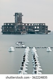 Old Wooden Stakes In Line And Ruins Of Torpedo Building