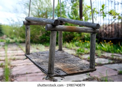 Old Wooden Swing On Ropes. No People.