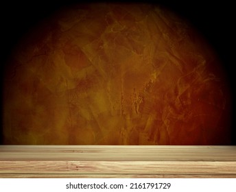 Old wooden table and stucco wall of brown color. Empty wooden table top with dark brown concrete wall background. Rustic wooden board on darken backdrop. Product display template. Copy space for text - Shutterstock ID 2161791729