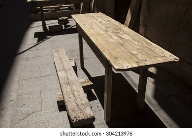 Old wooden tables at an outdoor cafe in Spain - Shutterstock ID 304213976
