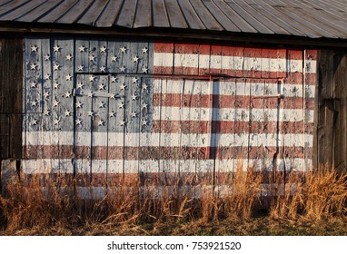 old wooden tobacco barn with United States flag painted on side, Calvert County, Southern Maryland, USA