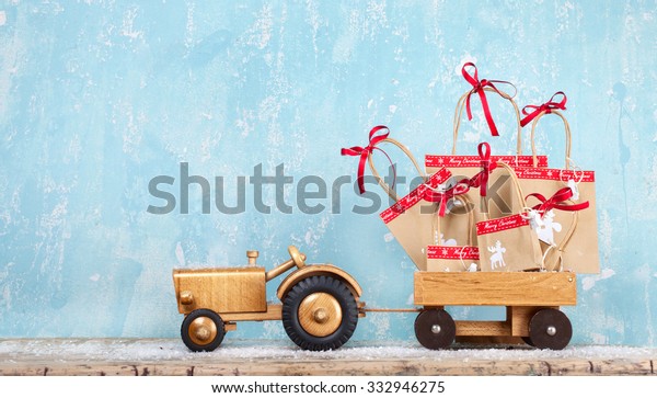 old wooden toy tractor with Handmade christmas gifts on
a trailer 