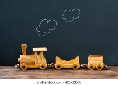 Old Wooden Toy Train With Steam On The Chalkboard Background