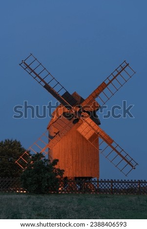 Old wooden, traditional windmill at sunset on a field, Germany