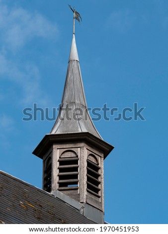 Old wooden turret with a lead roof and a blue sky as a background