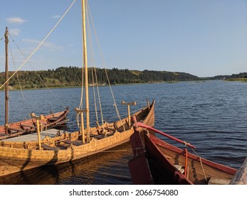 Old wooden viking snekkja longship type. Scandinavian wooden ships moored on the shore Historical reenactment, nordic culture, nautical vessel, tall ship, historical reenactment, nordic culture.