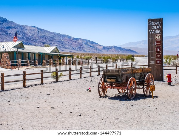 An old wooden wagon in a desert scene at Stove-Pipe\
Wells taken in 2007