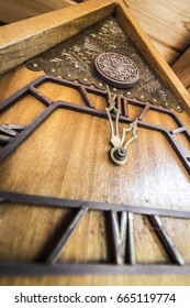 Old Wooden Wall Clock With A Cuckoo Close Up.