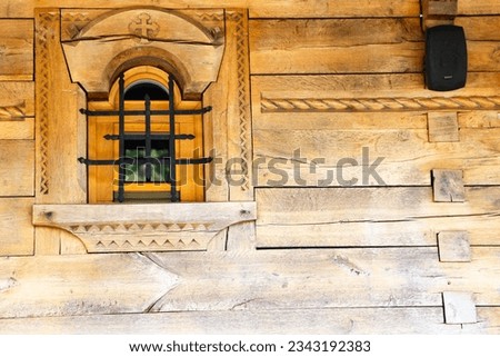 Old wooden window with bars, place at the Monastery, small church, Maramures Romania