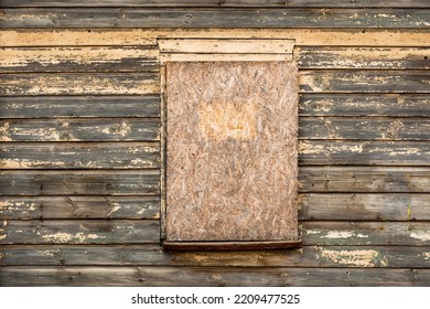 An Old Wooden Window Boarded Up With Plywood On A Wooden Wall. Easy Way To Repair Windows Of A Poor House.