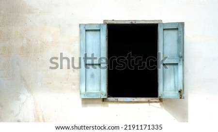 old wooden window on old wall.