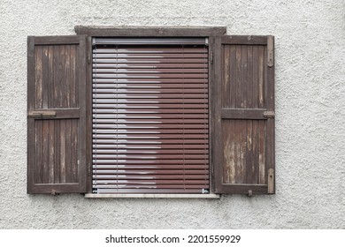 Old Wooden Window With Open Shutter And Roll Up Jalousie, Bright Cement Wall With Rough Surface, No People