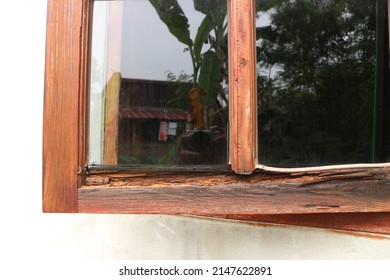 Old wooden window with peeling paint and durt needed to be repaired.