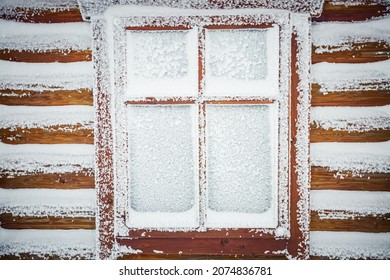 Old Wooden Window With Snow And Frozen Glass. Retro Frame In Christmas Time. Severe Frost Freezes The House. The Power Of Nature Concept. Abstract Natural Pattern. Beauty Of Earth.