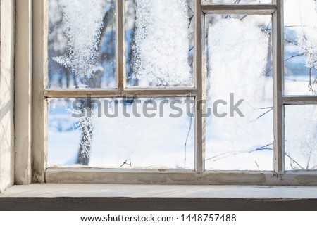old wooden window with winter frost