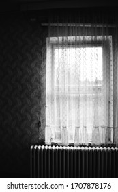 An Old Wooden Windows With Tattered Curtain In Black And White