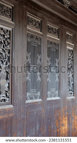The old wooden windows view with the beautiful carved sculpture in China