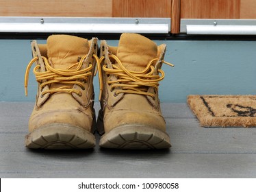 Old Work Boots On A Porch.