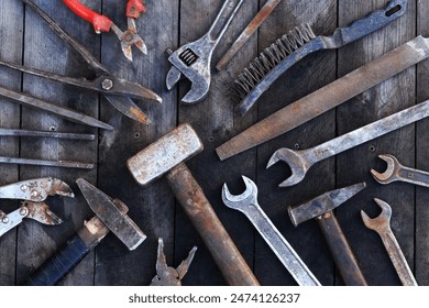 Old work tools on a wooden plank surface, top view. Hammers, sledgehammers, metal shears, pliers and more. Hand tool. Top view with copy space. Flat lay. Craftsmanship and handwork concept - Powered by Shutterstock