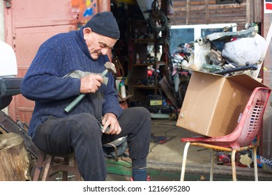 old worker at old workshop