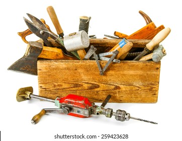 Old working tools. Working tools (drill, axe, saw and others) in an old box on white background.