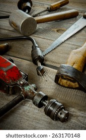 Old working tools. Various tools on a wooden background.