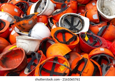 Old Worn Construction Safety Helmets. Selective Focus. Engineering Building Equipment. Plastic Recycling.The Concept Of Job Loss, Unemployment.