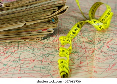 Old and worn fashion magazines are disclosed in the drawings of patterns with the measuring strip