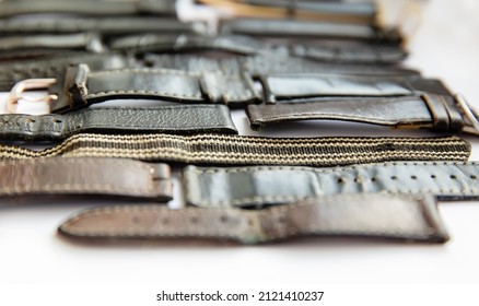 Old Worn Leather Watch Bracelets With A Clasp In A Pile.