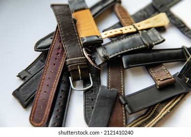 Old Worn Leather Watch Bracelets With A Clasp In A Pile.