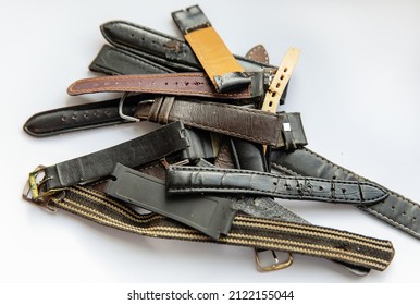 Old Worn Leather Watch Bracelets With A Clasp In A Pile.