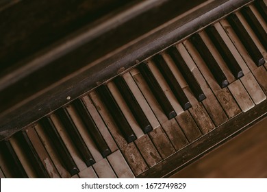 An Old Worn Out Piano. Old Key Board. Ancient Piano Background. Vintage Image Of The Piano. 