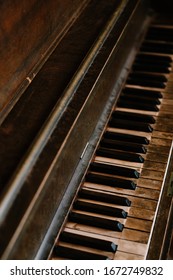 An Old Worn Out Piano. Old Key Board. Ancient Piano Background. Vintage Image Of The Piano. 