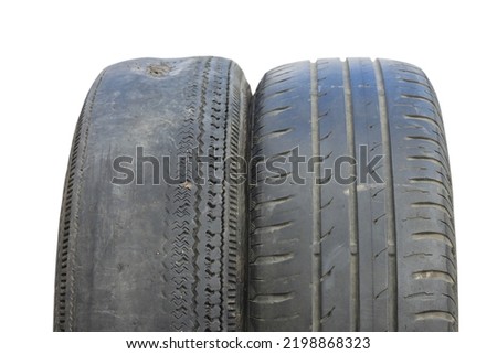 old worn out summer tire next to another old summer tire isolated on white background as sample of damaged summer tires from two summer tires