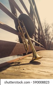 Old Worn Trumpet With Pork Pie Hat On Bridge