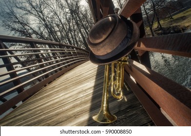 Old Worn Trumpet With Pork Pie Hat On Bridge