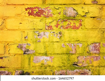 Old worn yellow brick wall background 
