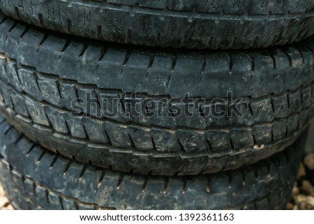 Old worn-out summer tires with worn-out protector close-up