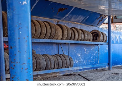 Old Worn-out Tires Are Stacked On A Metal Rack