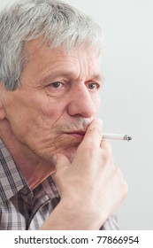 Old Worried And Thinking Man Smoking